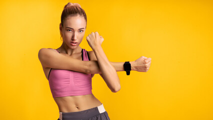 Wall Mural - Motivated Fitness Woman Doing Arm Stretch Exercise Standing Over Pink Studio Background. Panorama
