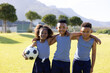 © wavebreak3 - Portrait of happy african american schoolchildren playing football on field at school