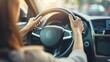 © SHOTPRIME STUDIO - Woman driving a car on a road trip with hands on steering wheel and eyes on the road