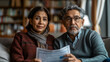 © Carmen - Mature Hispanic couple with serious expression, struggling to pay bills, copy space