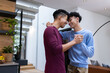 © Wavebreak Media - Smiling male gay couple dancing together in modern home, enjoying moment