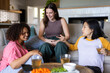 © Wavebreak Media - Relaxing at home, three women friends enjoying drinks and conversation on couch