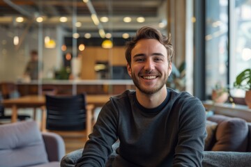 Wall Mural - smiling millennial male employee in coworking office