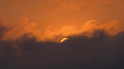 Wall Mural - dramatic sunrise with orange sky in a cloudy day.