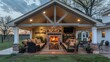 © Ramzan - Ranch house with a cozy, covered back patio, featuring a brick fireplace and comfortable seating