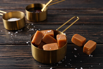 Sticker - Cubes of salted caramel with salt on a wooden table