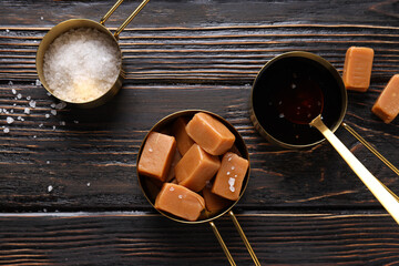 Sticker - Cubes of salted caramel with salt on a wooden table