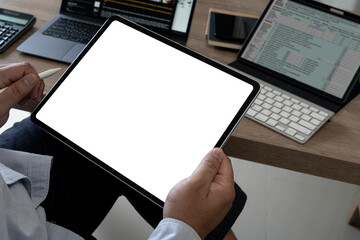Poster - A businessman holds a mockup. iPad digital tablet with blank screen Mockup replaces your design mockup in the office.
