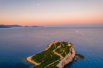 Lighthouse on the cliff. Seascape of Cape Lefkatas with old lighthouse on Lefkada island, Greece. Beautiful views of azure sea water and nature with cliffs