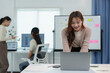 © crizzystudio - Young Asian businesswoman with creative colleagues working with laptop. Calculating.Financial management planning, analysis, startup project ideas, statistics and office investment markets.
