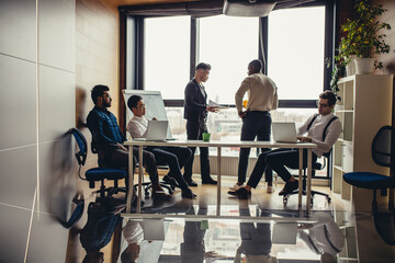 Wall Mural - Panoramic picture of multiracial group of people meeting in modern spacious office interior with a panoramic window