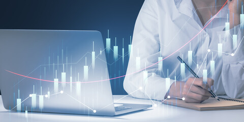 Poster - Close up of female hands working at office desk with laptop and paperwork, glowing growing business chart on blurry background. Financial growth and success concept.