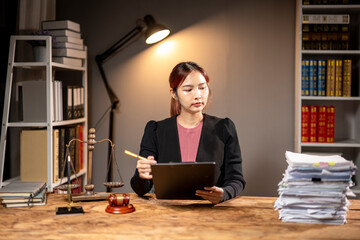 Wall Mural - She is looking at a tablet and she is focused on her work