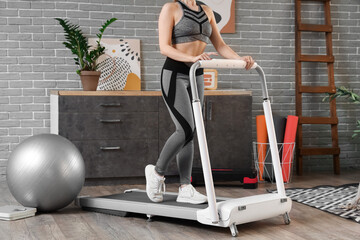 Poster - Sporty woman training on treadmill at home