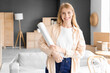 © Pixel-Shot - Young woman with stretch wrap in room on moving day