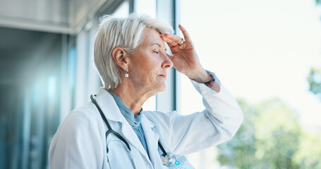 Poster - Senior woman, doctor and headache in stress, burnout or mistake against glass window in hospital building. Frustrated physician, medical healthcare and person in grief, loss or fatigue at clinic