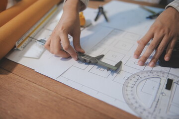 Wall Mural - engineer people meeting working and pointing at a blueprint in office for discussing. Engineering tools and construction concept