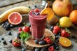 © Rumpa - A vibrant mixed berry smoothie served in a glass, garnished with an orange slice and surrounded by various fresh fruits.