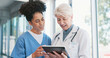 © peopleimages.com - Healthcare, tablet and doctor talking to nurse woman in hospital for consulting, diagnosis or results. Medical, smile and technology with medicine professional teaching intern or student in clinic