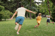 © arthurhidden - Father enjoying a playful day with his children in a green park. Family fun, outdoor activities, and bonding time captured in a natural setting.