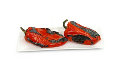 Wall Mural - Fire roasted sweet red pepper photographed on a white background. Grilled red bell peppers prepared for making salad. Delicious Roasted Red Pepper Isolated