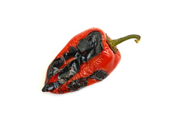 Wall Mural - Fire roasted sweet red pepper photographed on a white background. Grilled red bell peppers prepared for making salad. Delicious Roasted Red Pepper Isolated