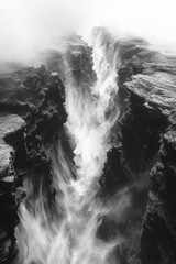 Ethereal Monochrome View of a Mist-Filled Chasm with Rugged Cliffs, Invoking Mystery and Nature's Power