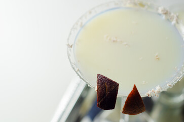 Canvas Print - A martini glass with a garnish of coconut flakes on top