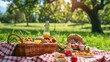 © Pornarun - A picturesque picnic scene with a basket full of goodies, a red checkered blanket, and a beautiful green park in the background.