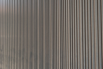 Wall Mural - Wall metal sheet texture background for modern design. Silver aluminum shiny for roof warehouse. Texture of corrugated sheet metal facade. Panorama of black metal texture surface galvanized steel