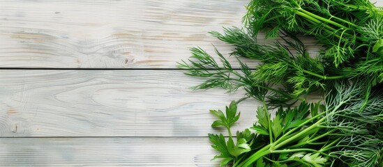 Poster - Closeup of dill and parsley on a light wooden table creating a picturesque copy space image.