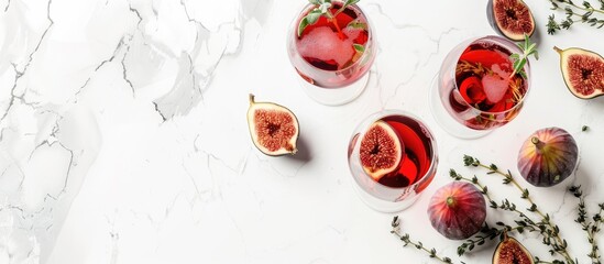 Poster - Copy space image of a red wine, thyme, and figs autumn cocktail on a white marble table.