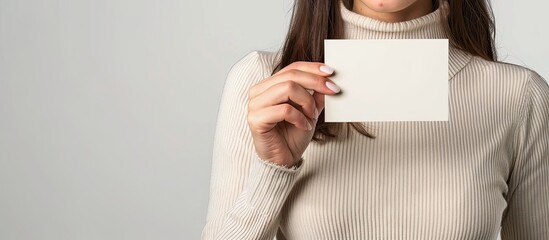 Aufkleber - Female teenager holding a blank business card, positioned against a white backdrop for a copy space image.