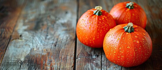 Poster - Cut ripe pumpkins placed on a wooden table with space for text or graphics. image with copy space