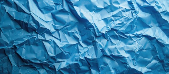 Fototapete - Background with blue crumpled paper texture providing copy space image.