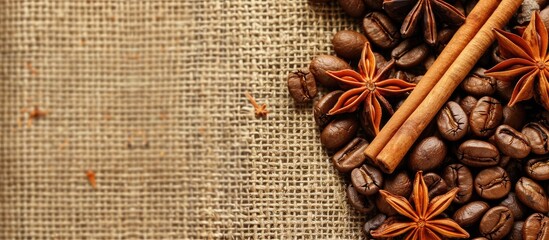 Aufkleber - Brown burlap background with roasted coffee beans, anise stars, and cinnamon sticks. Hot orange-brown hues with room for text in the image. image with copy space