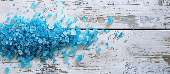 Wall Mural - blue bath salts displayed on a weathered white wooden table with empty space for pictures. image wit