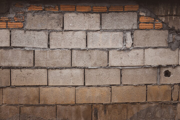 Wall Mural - A wall made of bricks with a hole in it. The wall is grey and brown