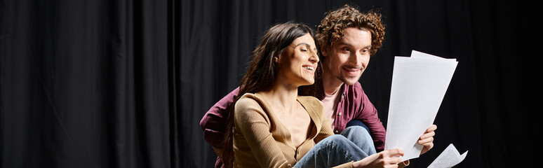 Wall Mural - Man and woman on stage, holding scripts.