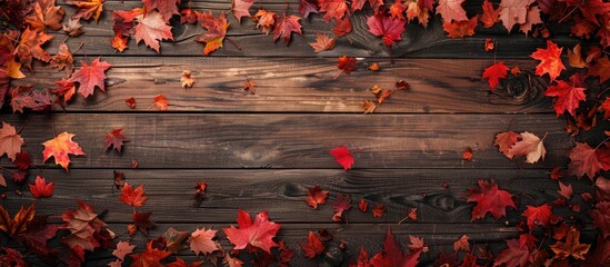 Wall Mural - Top view of a wooden background adorned with autumn maple leaves, featuring a copy space image.