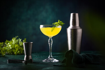 Poster - Tropical yellow lemon cocktail on green background