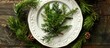 © StockKing - Top-down view of a festive plate decorated with green fir branches, emphasizing a holiday dinner theme with room for additional elements in the frame.