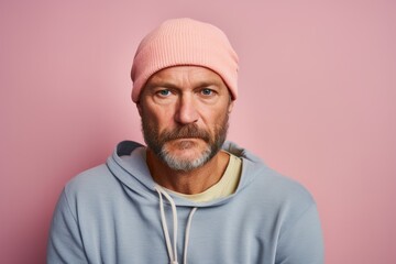 Canvas Print - Portrait of a merry man in his 40s sporting a trendy beanie over pastel or soft colors background