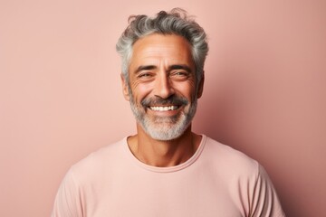 Canvas Print - Portrait of a joyful man in his 50s wearing a simple cotton shirt on pastel or soft colors background