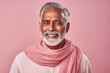 © Markus Schröder - Portrait of a cheerful indian man in his 50s wearing a versatile buff in front of pastel or soft colors background