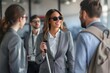 © Oscar - Blind Latin American business woman talking to her coworkers in the office