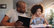 © WesSide/peopleimages.com - Father, boy and tablet for homework, learning and helping hand for counting, guide or solution in family house. African man, child and app for math with support, notebook and education at apartment