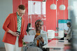 © pressmaster - Caucasian and African American female colleagues working together in office, one using tablet and the other holding coffee cup while reviewing documents