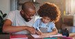 © WesSide/peopleimages.com - Father, boy and notebook for writing, learning or helping hand for advice with problem solving in family home. African man, child and education for development, math or check at apartment in New York