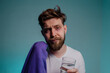 © phoenix021 - Man having insomnia problems holding blanket and glass of water, dark circles under eyes